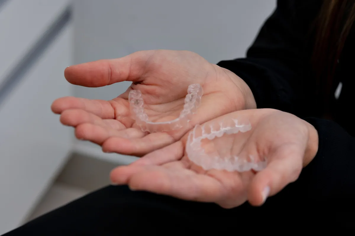 The same photograph of two clear aligner trays, ungraded.
