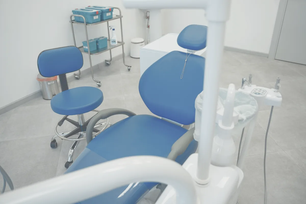 A clean, modern orthodontic surgery with the chair prepared.